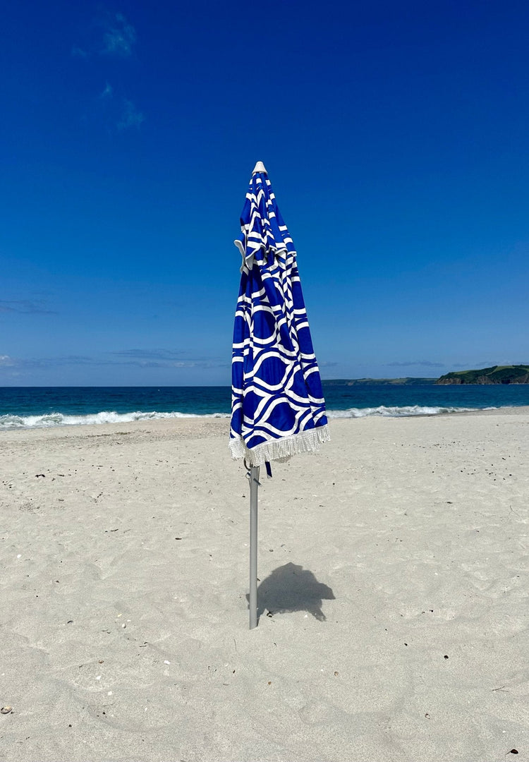 Classic Fringe Beach Umbrella Moroccan Blue 210cm on sandy beach with fringe detail and circular pattern