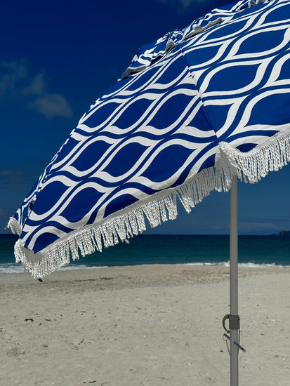 Classic Fringe Beach Umbrella Moroccan Blue 210cm with retro fringe on sandy beach