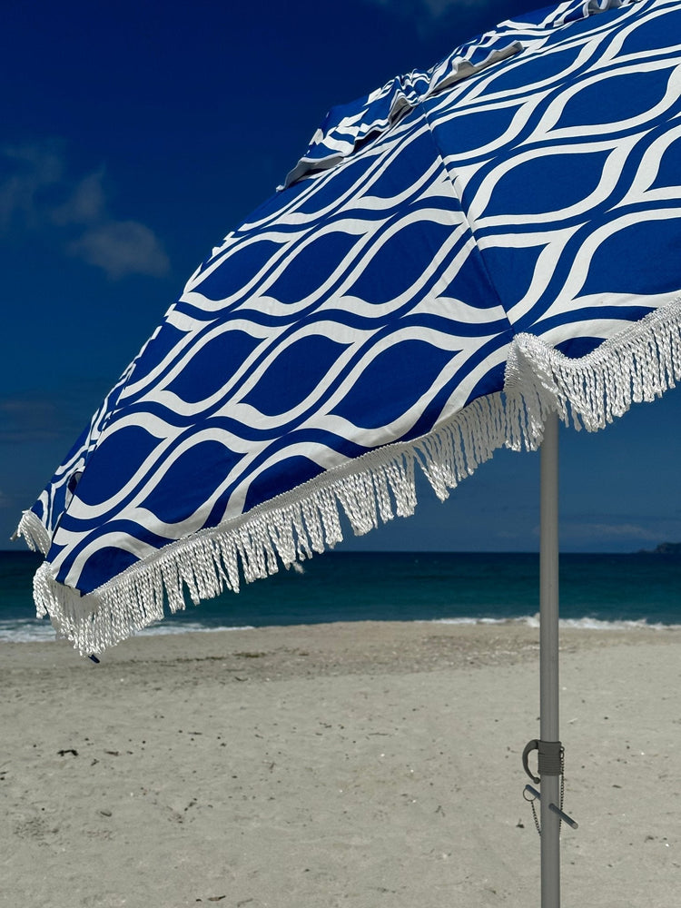 Classic Fringe Beach Umbrella Moroccan Blue 210cm with retro fringe on sandy beach