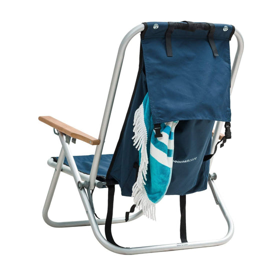 Beachkit Wearever Backpack Chair with aluminum frame, backpack design, wooden arms, and blue fabric seat with towel hanging.