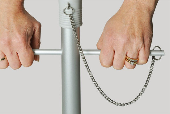 Hands using twist anchoring system on Beach Umbrella pole